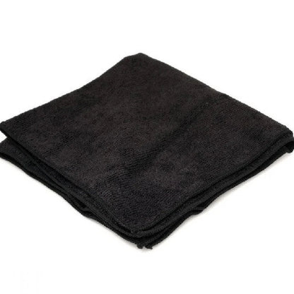 Folded black towel on a white background